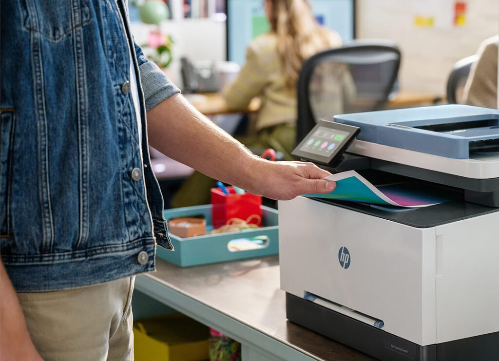 Man operating HP printer.